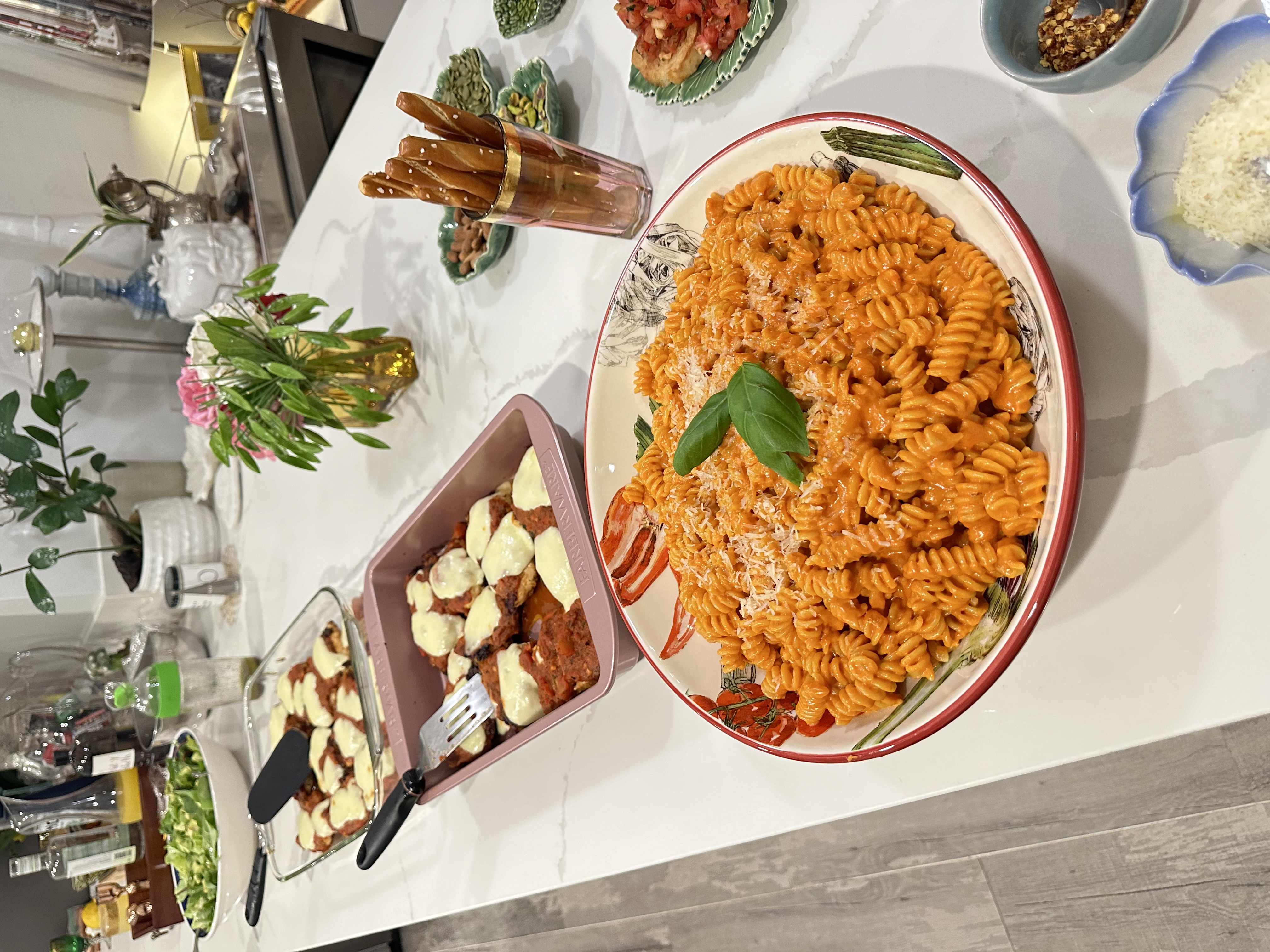 Pink sauce rotini family-style with mozzarella and meatball sides