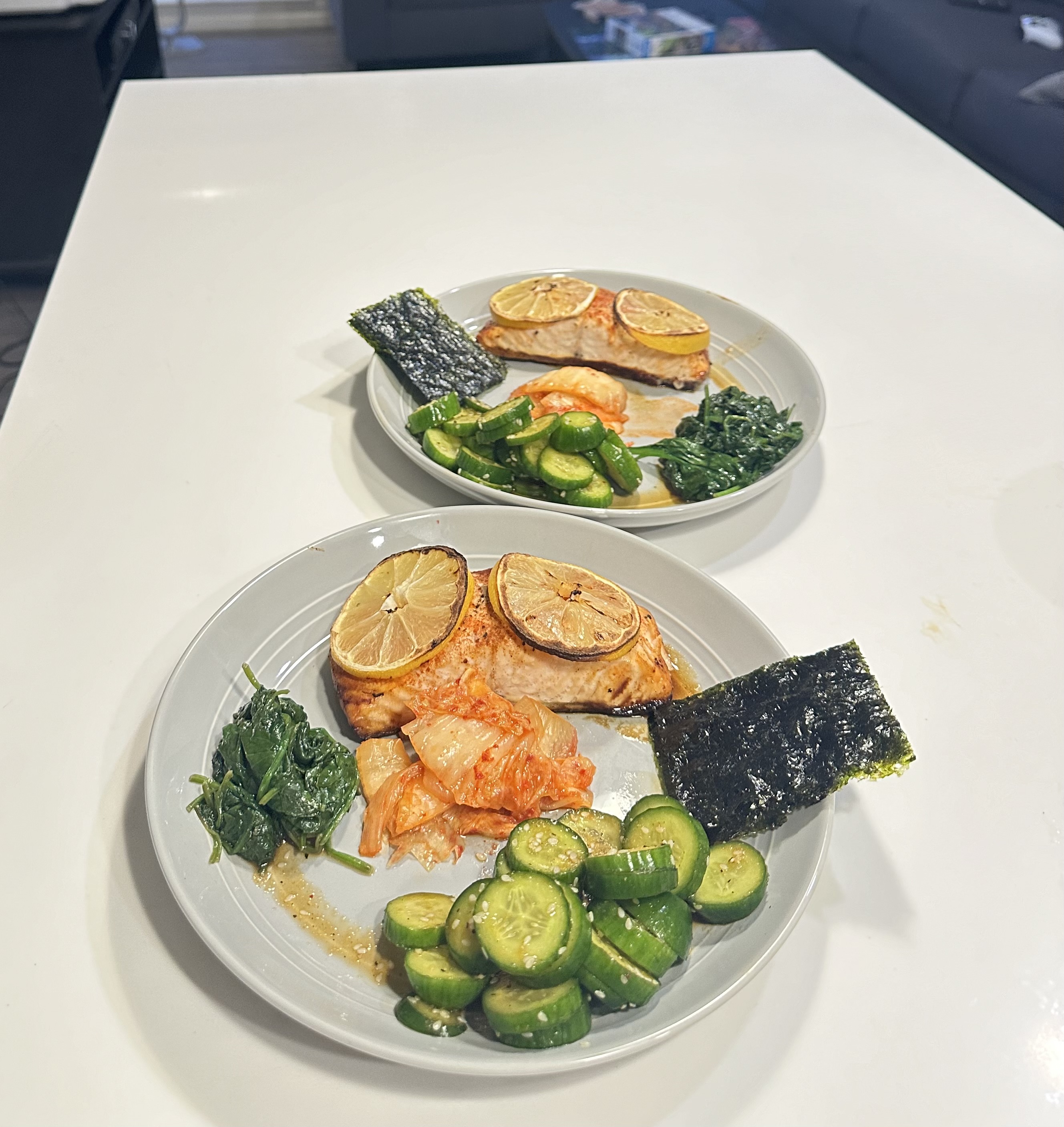 Lemon salmon plate with cucumber, spinach, kimchi, and nori
