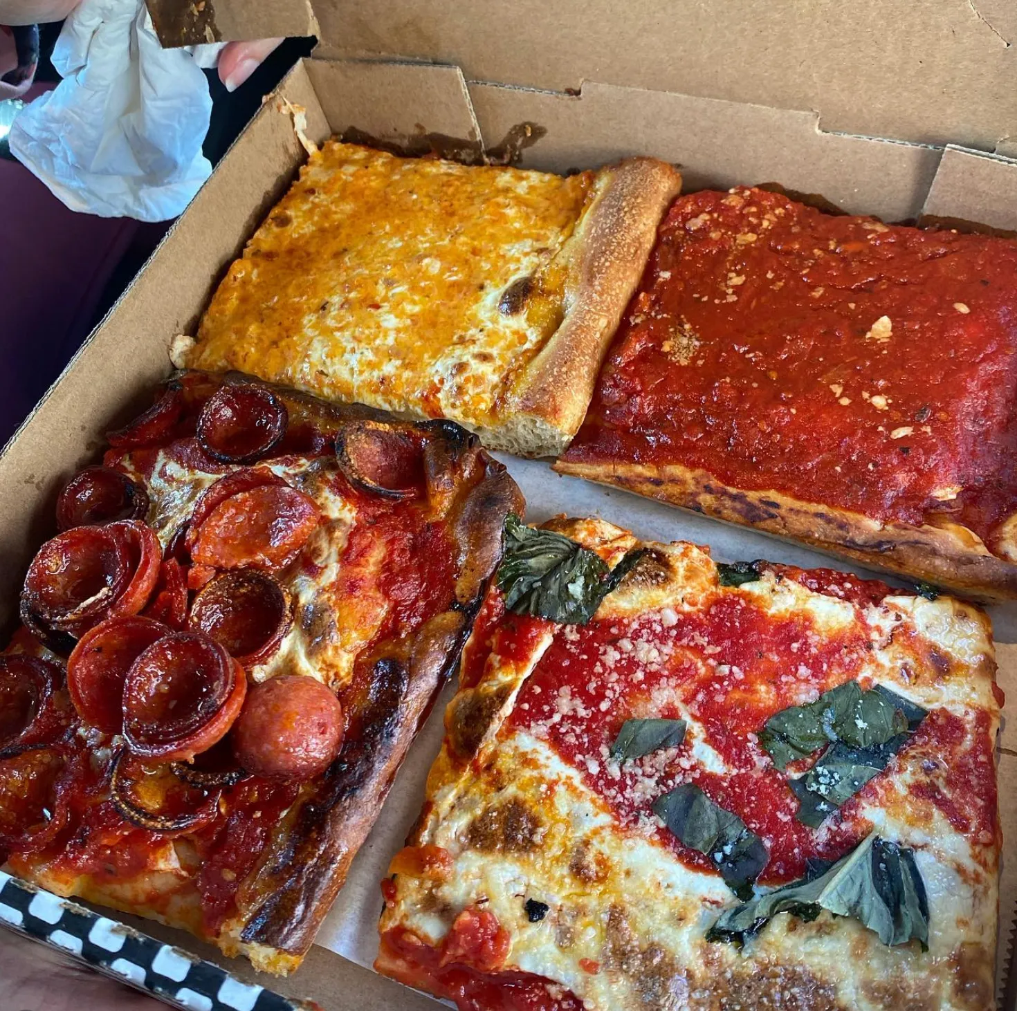 Prince Street Pizza square slices in a checkered box